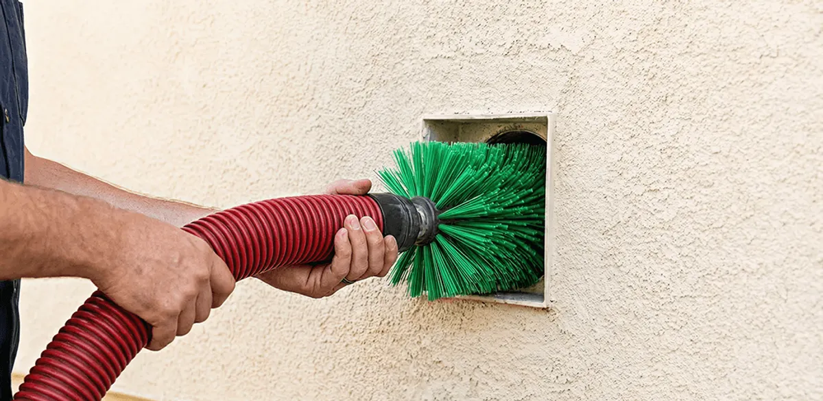 Air duct cleaning brush removing debris from a vent opening in Gilbert, AZ