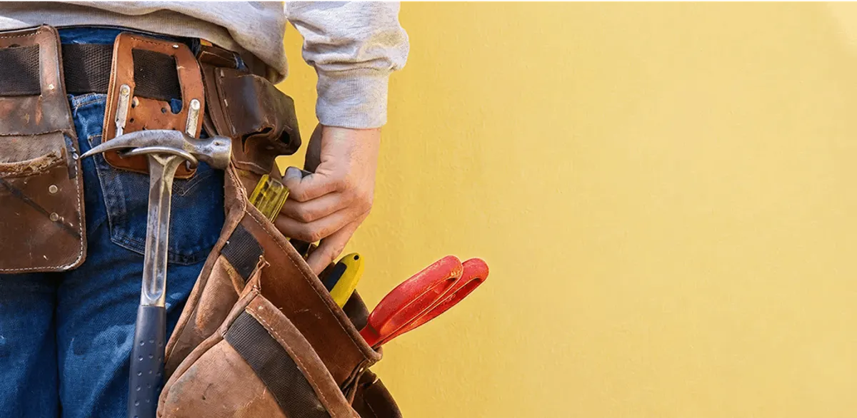 Handyman with tool belt ready for home repairs and maintenance in Gilbert, AZ