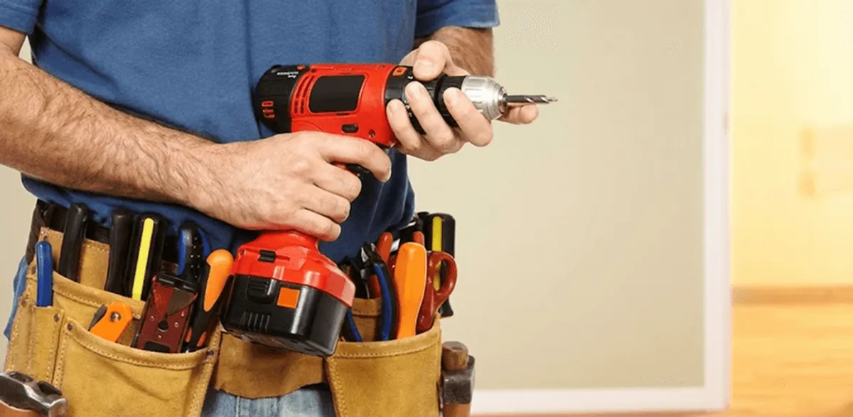 Handyman holding a power drill for home repairs and installations in Gilbert, AZ