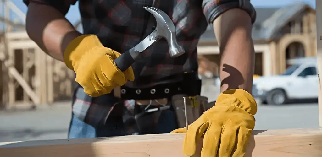 Handyman fixing wood trim with a hammer for home repairs in Gilbert, AZ