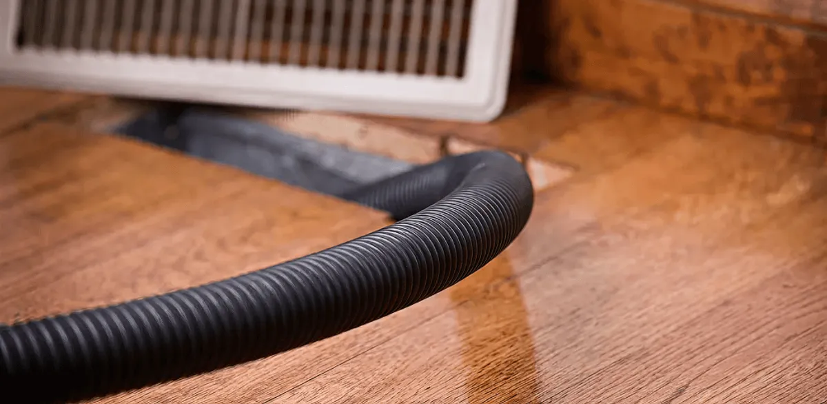 Air duct cleaning hose inserted into a floor vent for ductwork cleaning in Gilbert, AZ