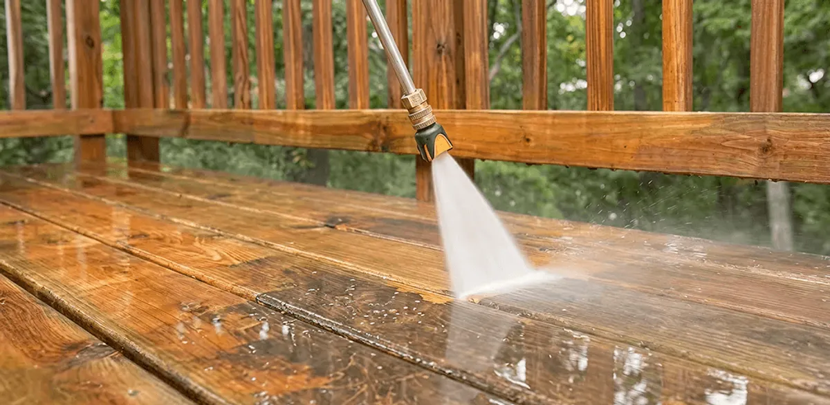 Pressure washing a wood deck to remove dirt and buildup in Gilbert, AZ
