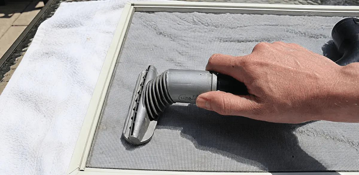 Window screen repair cleaning and fixing a damaged screen mesh in Gilbert, AZ